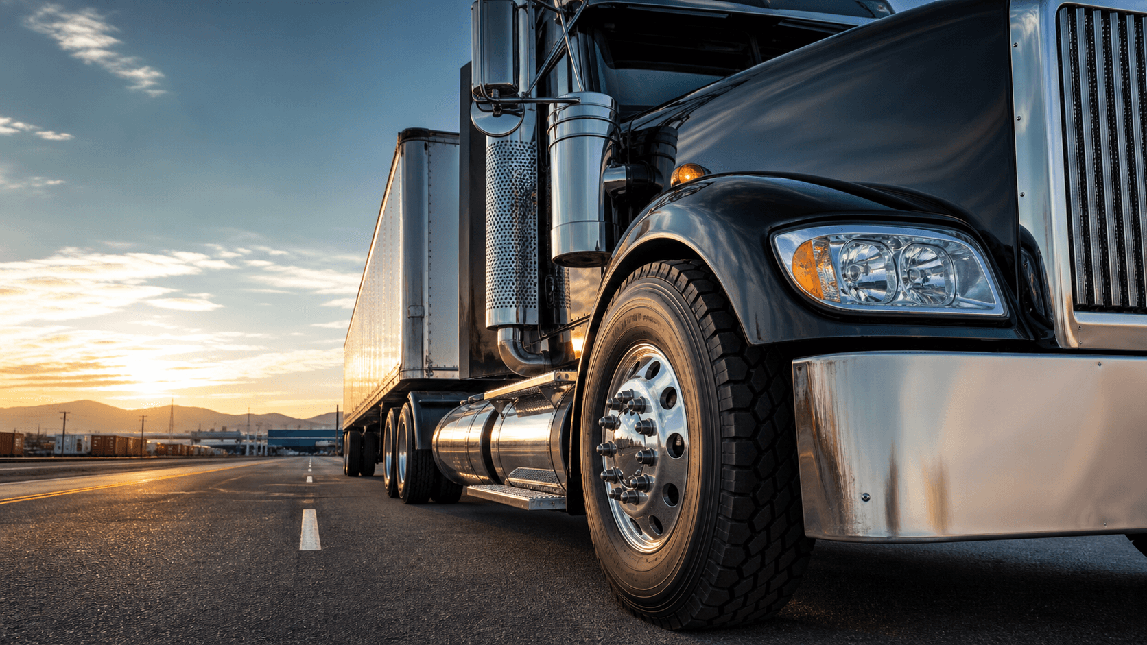 Commercial semi truck with oversized truck tires on a freight corridor